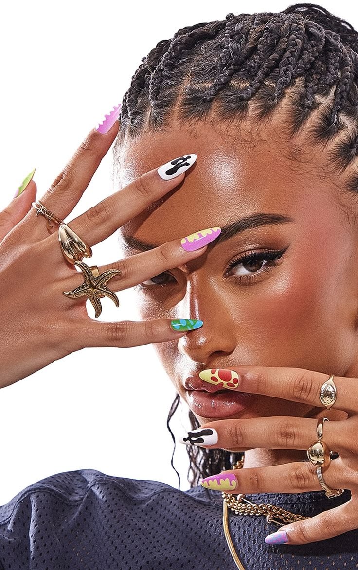 Woman with stylish nails and jewelry, covering her face with her hands.